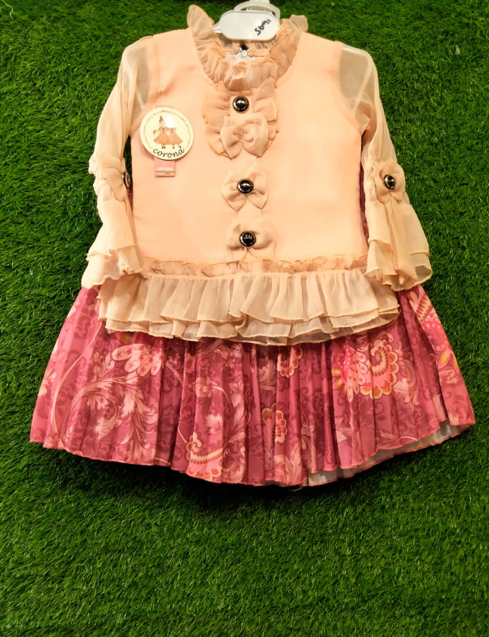 Girls Peach Top with Ruffle Sleeves & Printed Pleated Skirt Stylish Party Wear Dress Set | Elegant Bow & Button Detail